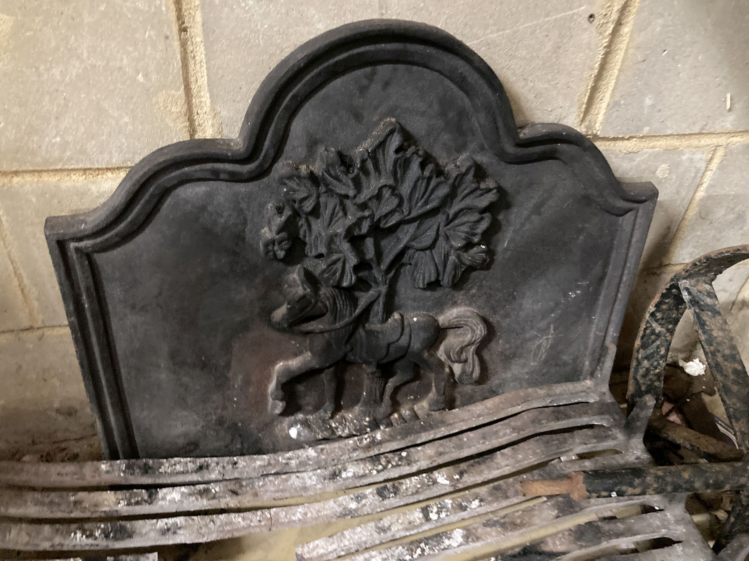 A fireside set comprising of cast iron fire back, basket, width 92cm, height 43cm, pair of dogs and a hammered cowl